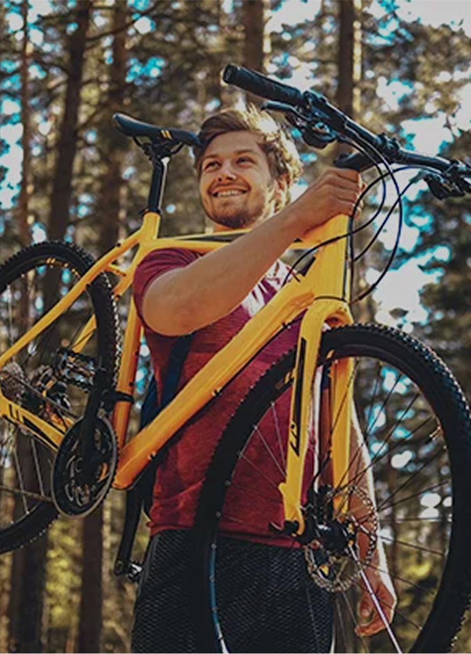 Young man with bicycle outdoors